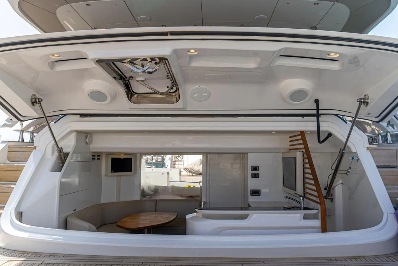 The aft deck features a cozy seating area with a table and modern amenities. aboard SEMIA Yacht for Sale