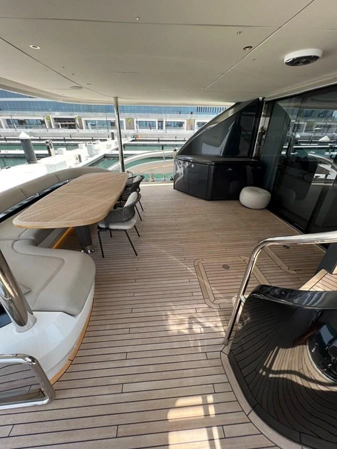 The aft deck features a spacious dining area with a sleek, modern design. aboard SEMIA Yacht for Sale