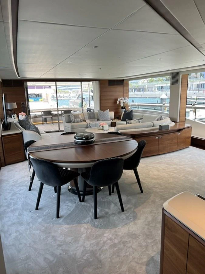 The yacht's salon features elegant furnishings and ample natural light through large windows. aboard SEMIA Yacht for Sale