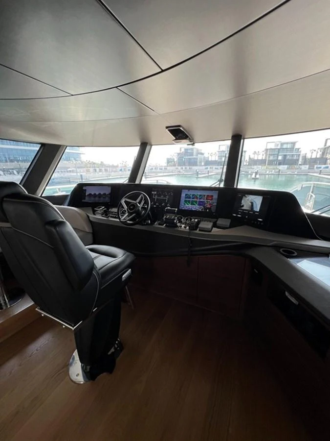 The helm station features advanced navigation equipment and a comfortable captain's chair, offering a commanding view of the surroundings. aboard SEMIA Yacht for Sale
