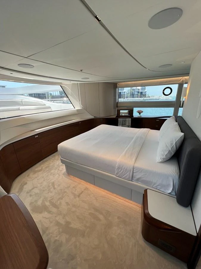 A luxurious stateroom with a large bed and panoramic windows offering stunning sea views. aboard SEMIA Yacht for Sale