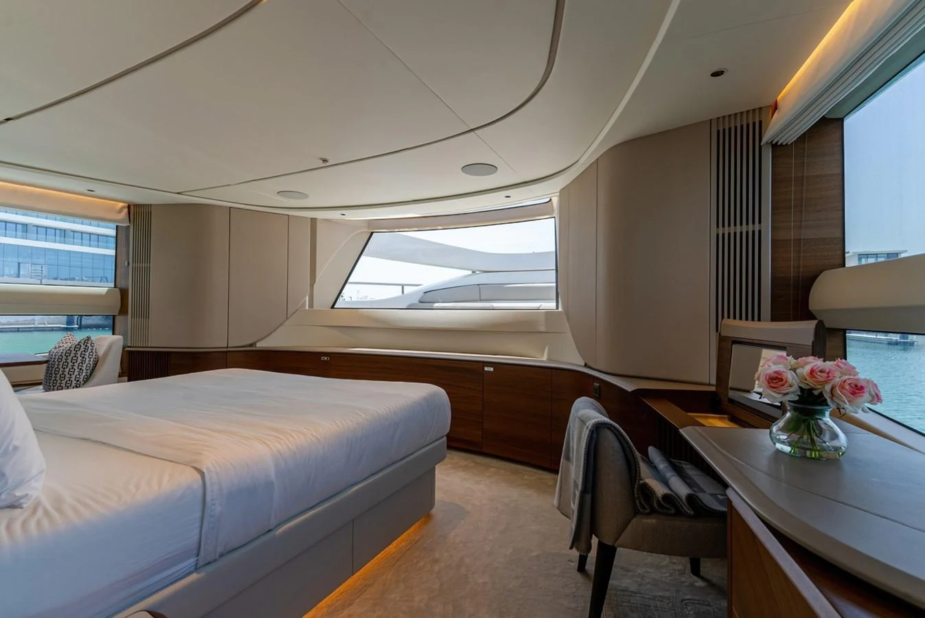 The stateroom features a luxurious bed, elegant furnishings, and large windows offering stunning views. aboard SEMIA Yacht for Sale