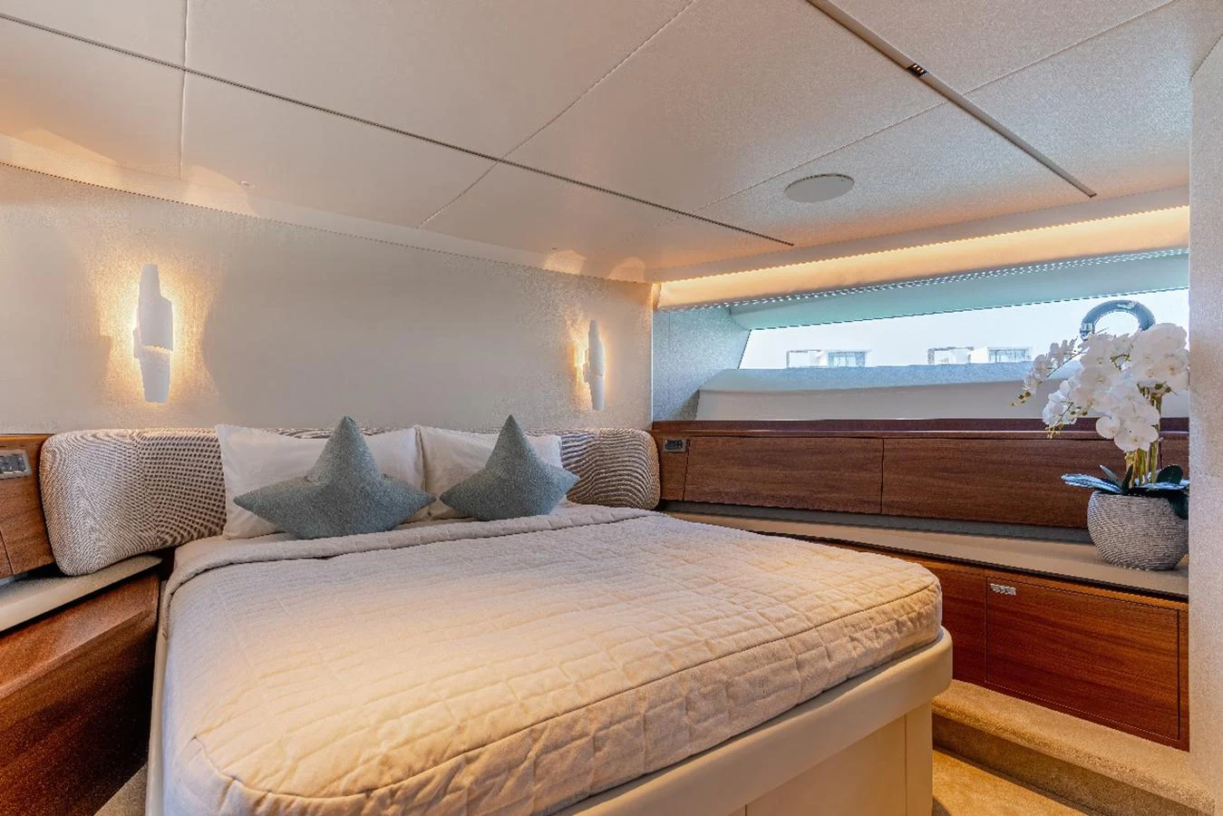 The stateroom features a plush bed with elegant lighting and a serene ambiance. aboard SEMIA Yacht for Sale