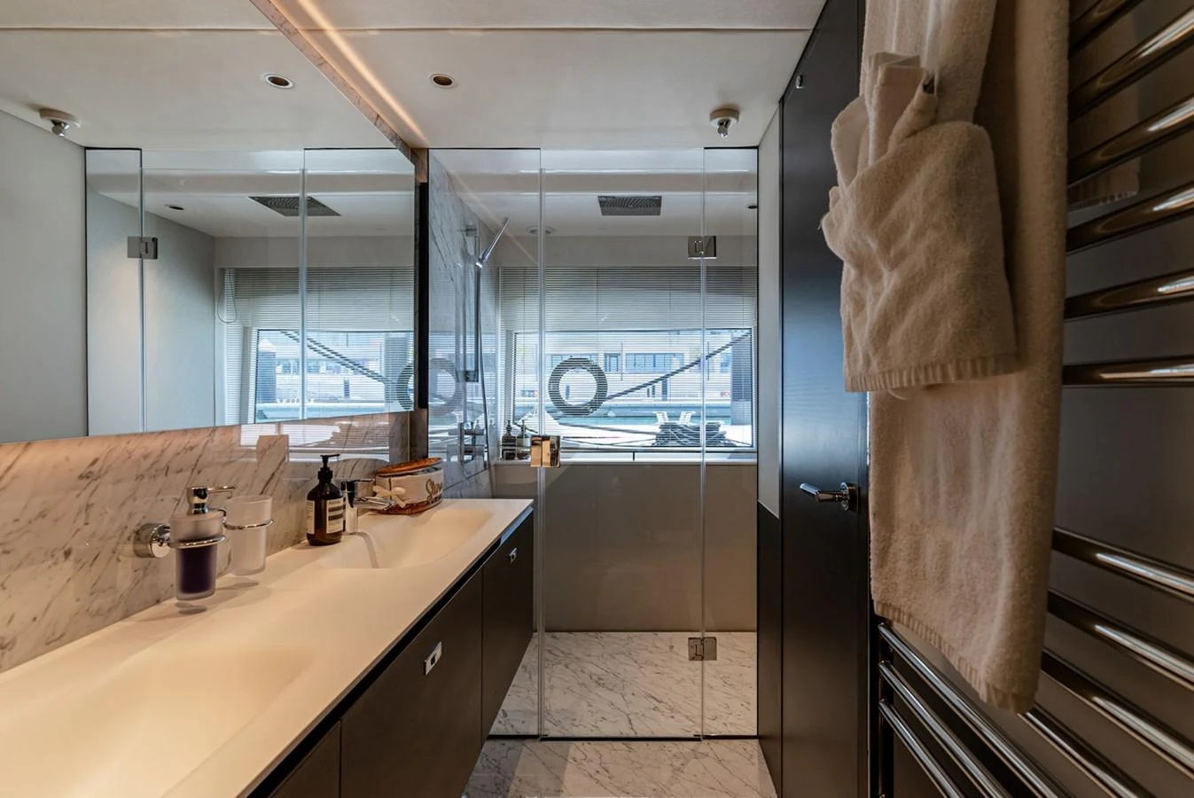 The yacht's bathroom features a sleek, modern design with a spacious shower and elegant fixtures. aboard SEMIA Yacht for Sale