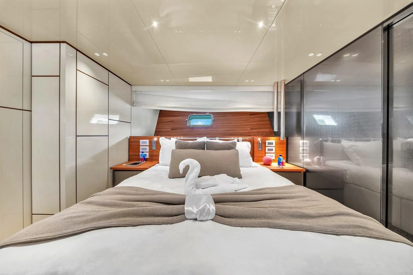 The stateroom features a plush bed with elegant linens and modern lighting, creating a cozy and luxurious atmosphere. aboard AIDA Yacht for Sale