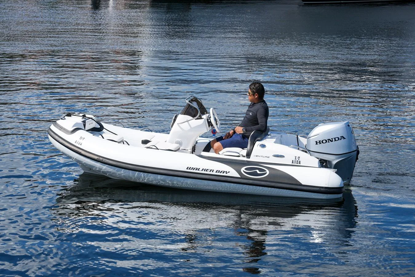 A sleek tender with a Honda outboard motor glides on calm waters. aboard AIDA Yacht for Sale