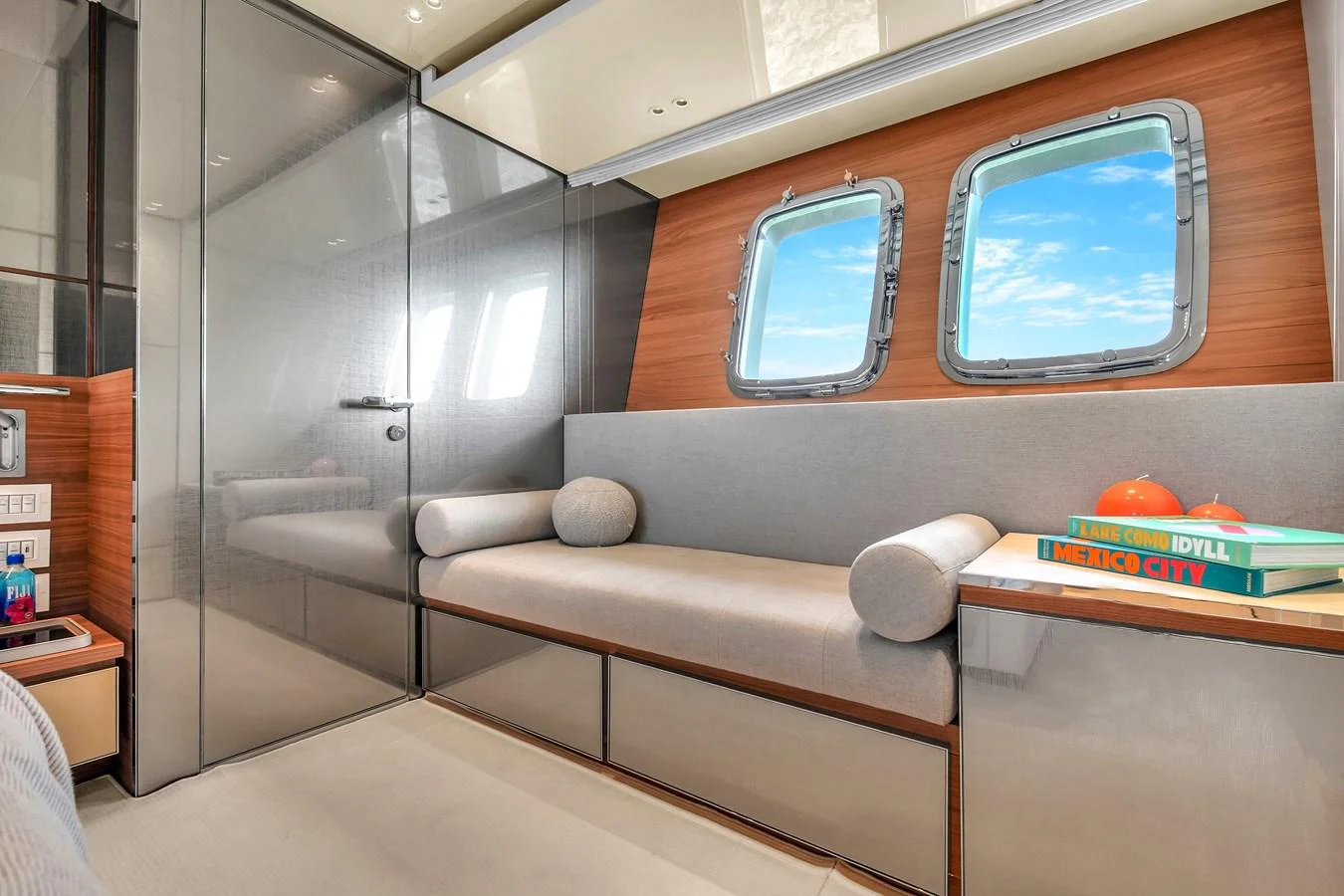 The yacht's interior features a cozy seating area with large windows offering a view of the sea. aboard AIDA Yacht for Sale