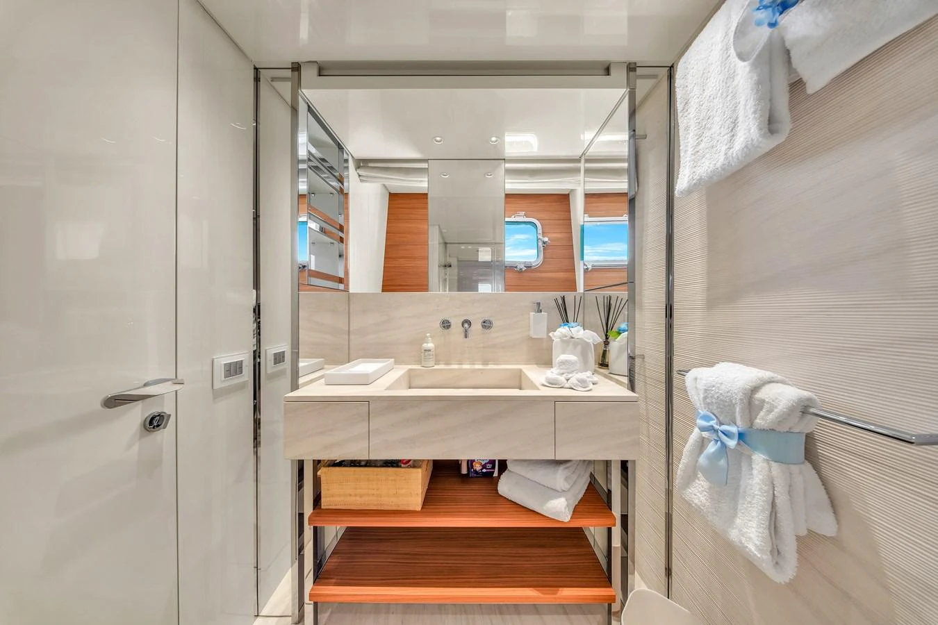The yacht's bathroom features a modern sink area with ample storage and elegant fixtures. aboard AIDA Yacht for Sale