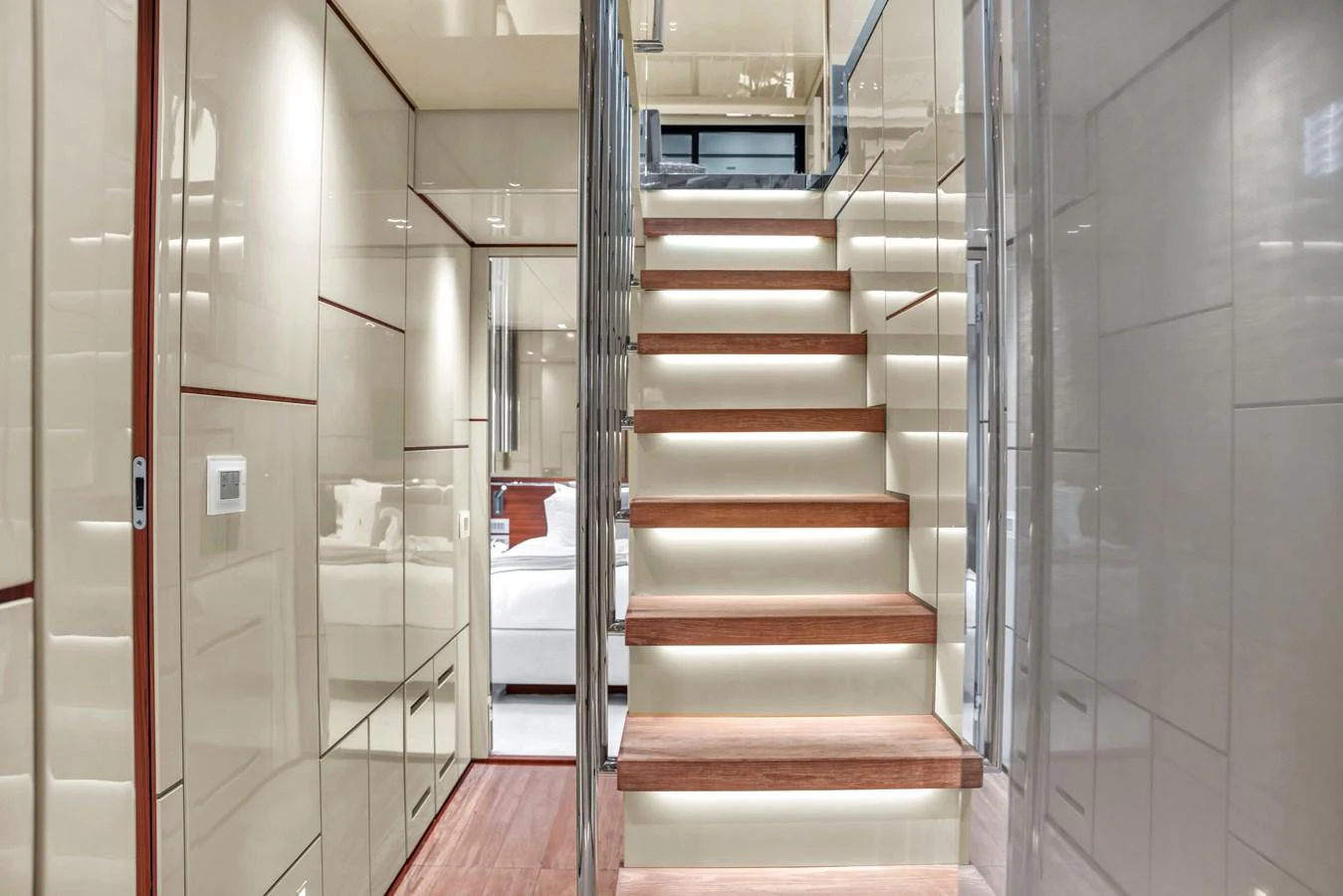 A modern yacht interior featuring a sleek staircase with illuminated steps and polished surfaces. aboard AIDA Yacht for Sale