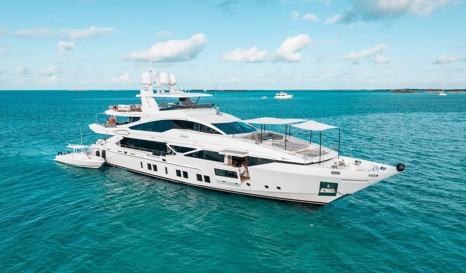 A sleek and modern yacht cruising on clear blue waters under a bright sky. aboard EMINA Yacht for Sale