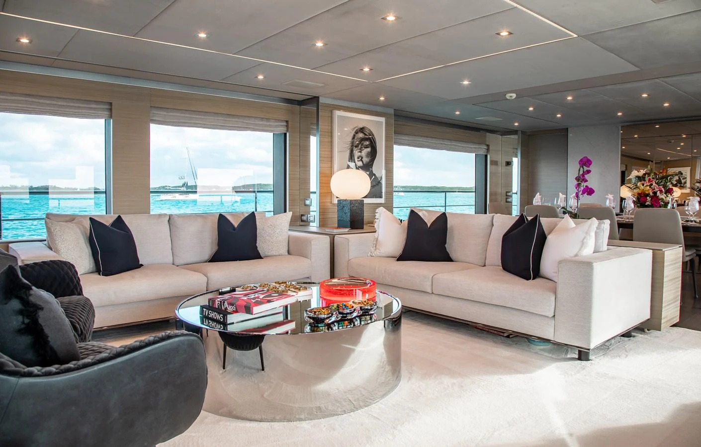 The salon features luxurious seating with large windows offering stunning ocean views. aboard EMINA Yacht for Sale