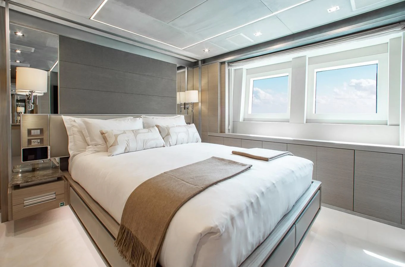 The stateroom offers a serene and luxurious retreat with large windows and elegant decor. aboard EMINA Yacht for Sale
