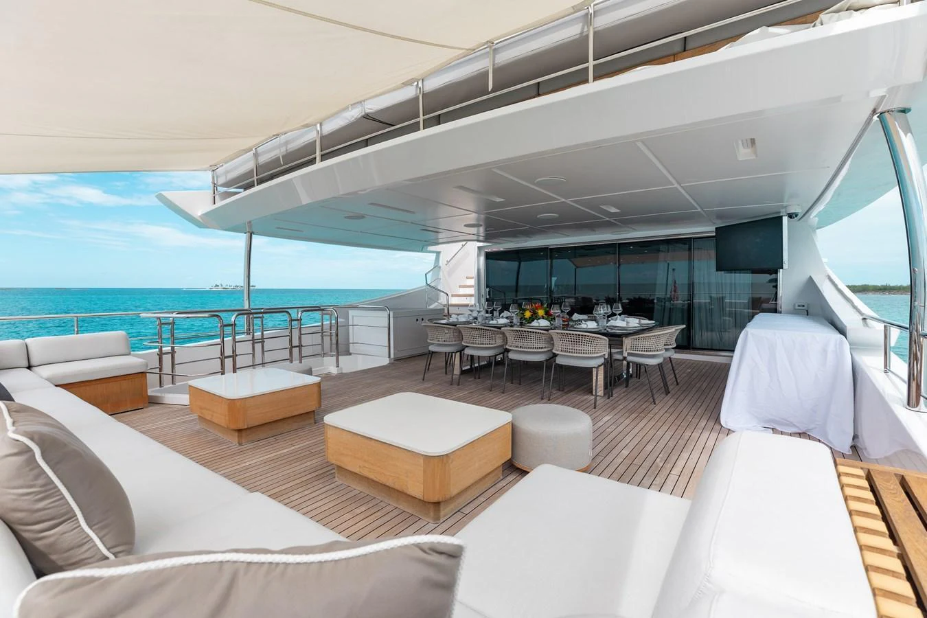The aft deck offers a spacious and elegant outdoor dining and lounging area with stunning ocean views. aboard EMINA Yacht for Sale