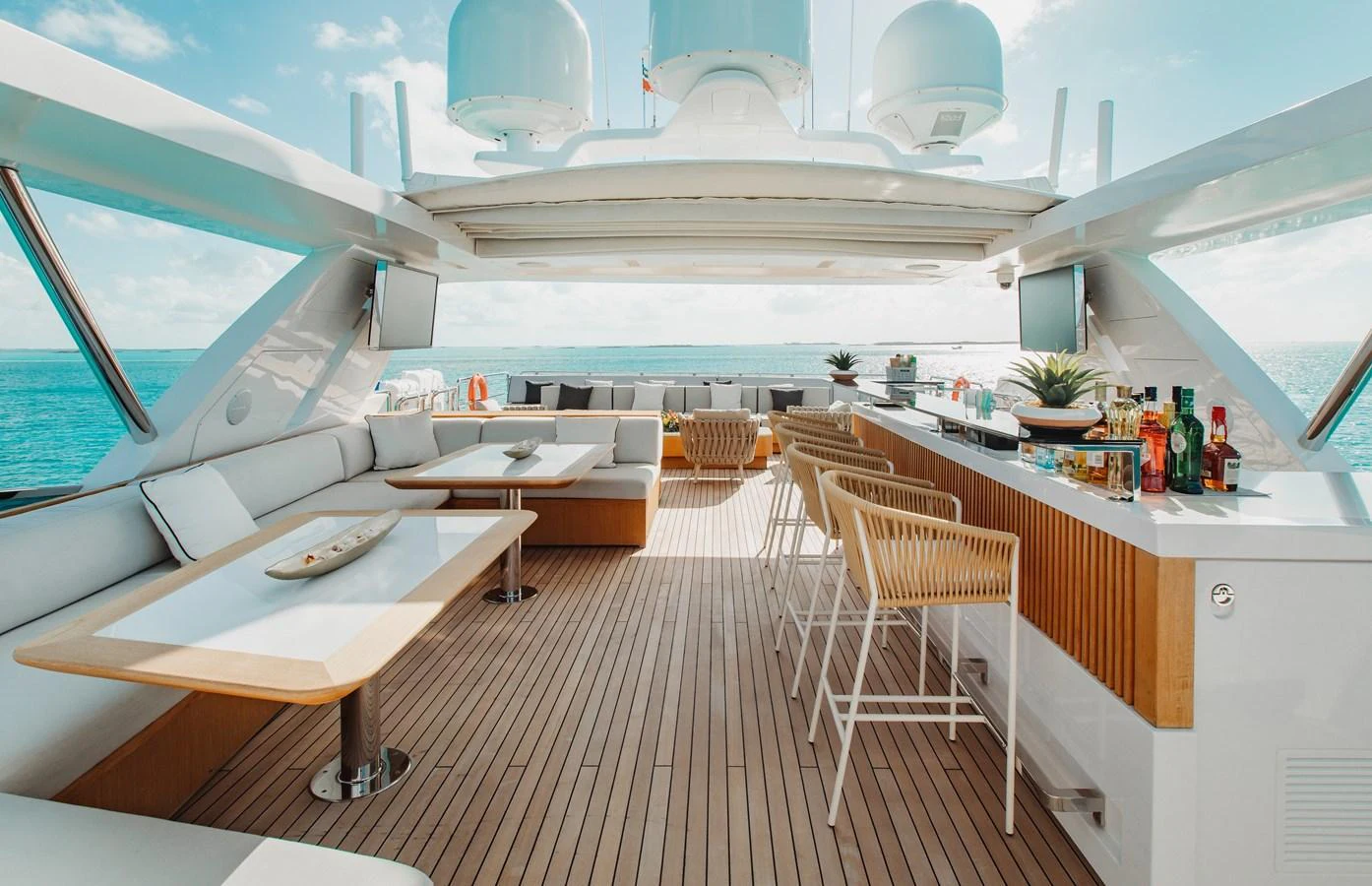 The flybridge features a spacious bar and dining area with panoramic ocean views. aboard EMINA Yacht for Sale