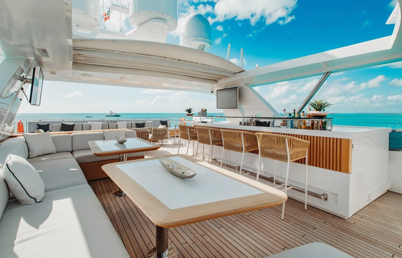 The flybridge offers a luxurious outdoor lounge area with ample seating and a well-equipped bar, perfect for relaxation and entertainment. aboard EMINA Yacht for Sale