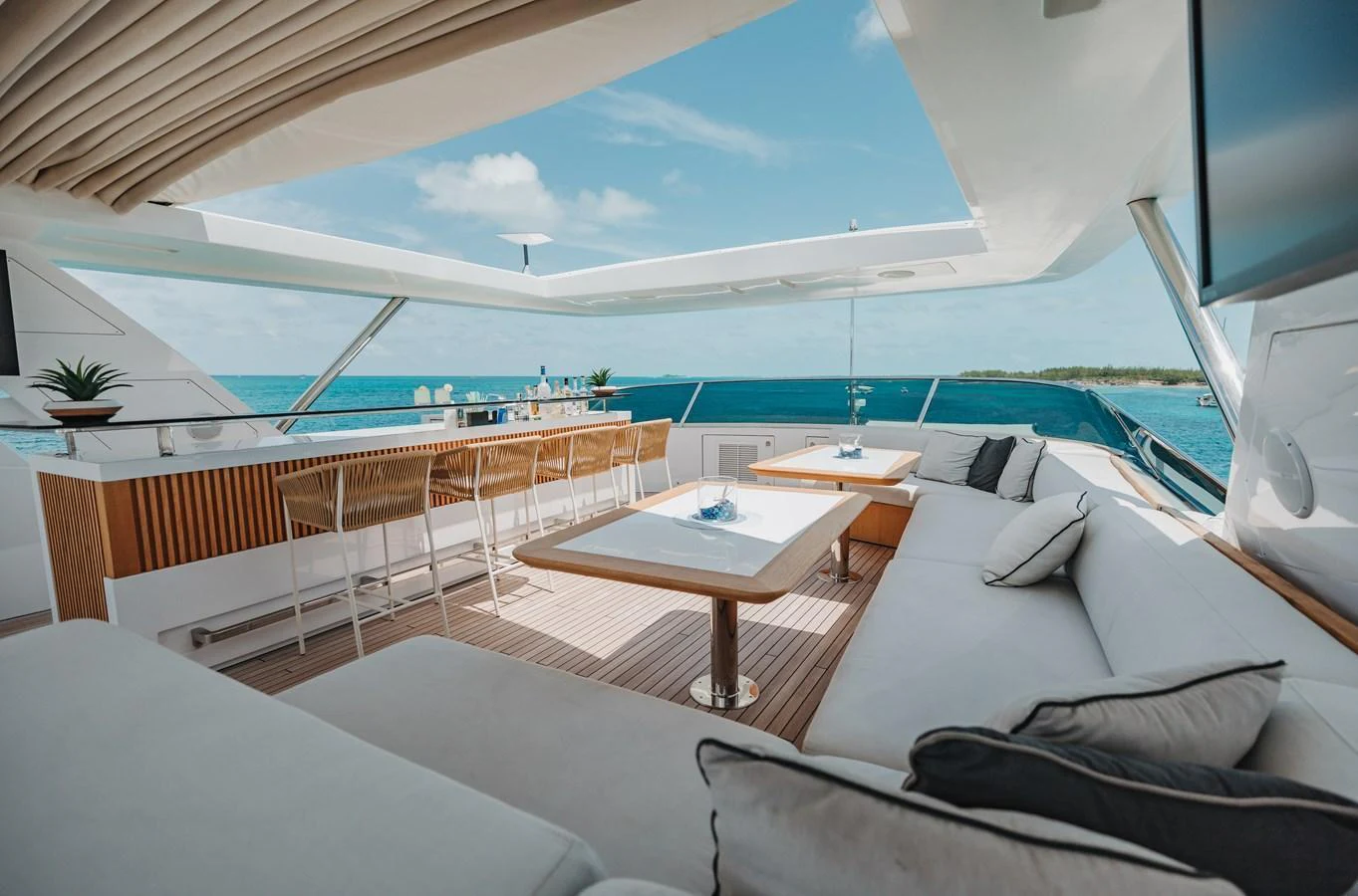 The flybridge offers a luxurious outdoor lounge area with stunning ocean views. aboard EMINA Yacht for Sale