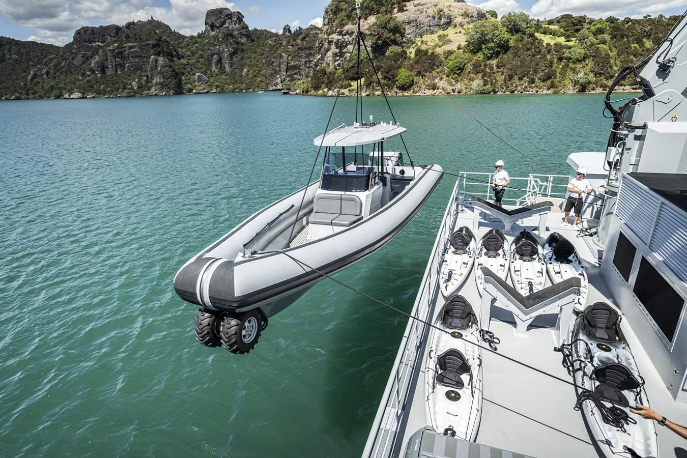 A sleek tender is being lowered into the water from the yacht's deck, showcasing the vessel's versatility and readiness for adventure. aboard THE BEAST Yacht for Sale