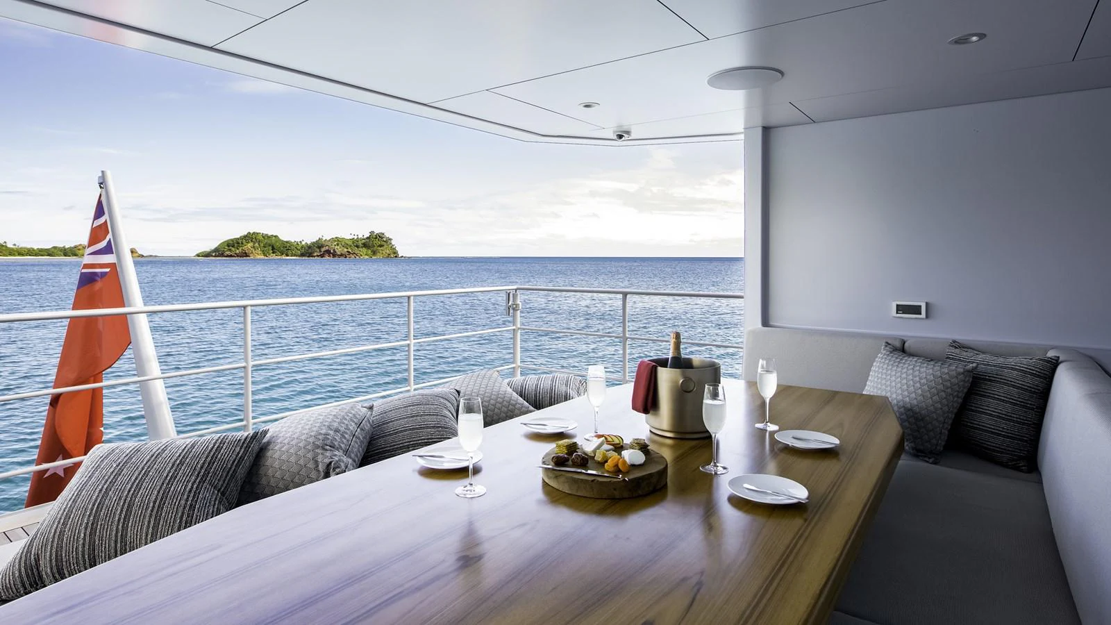 The aft deck features a comfortable dining area with a stunning ocean view. aboard THE BEAST Yacht for Sale