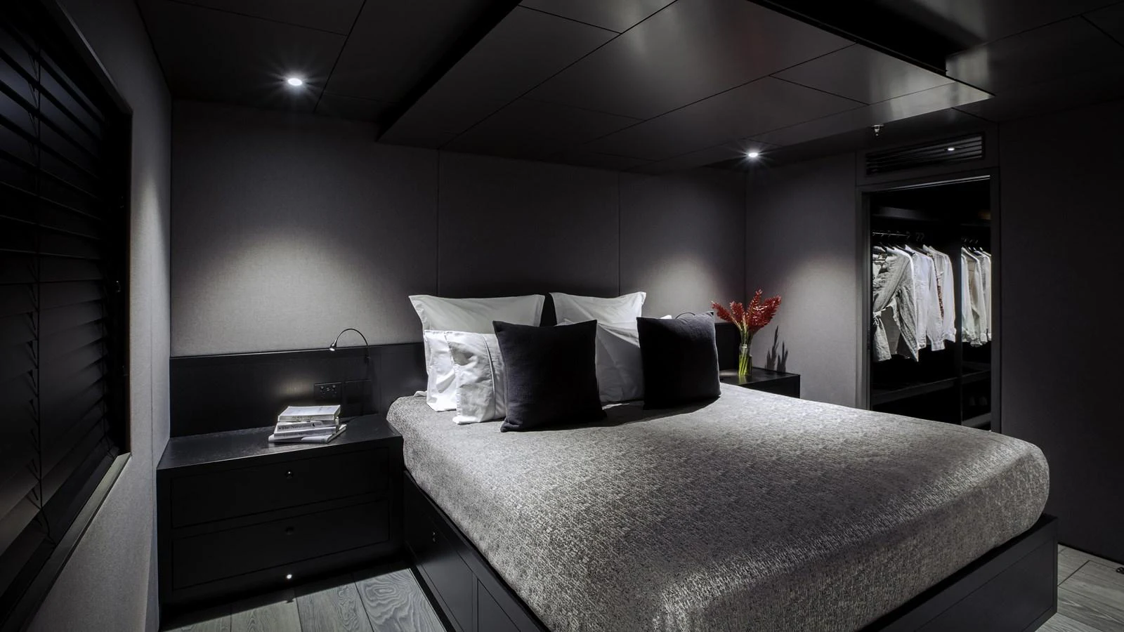 A luxurious stateroom featuring a large bed with plush pillows and a modern, minimalist design. aboard THE BEAST Yacht for Sale