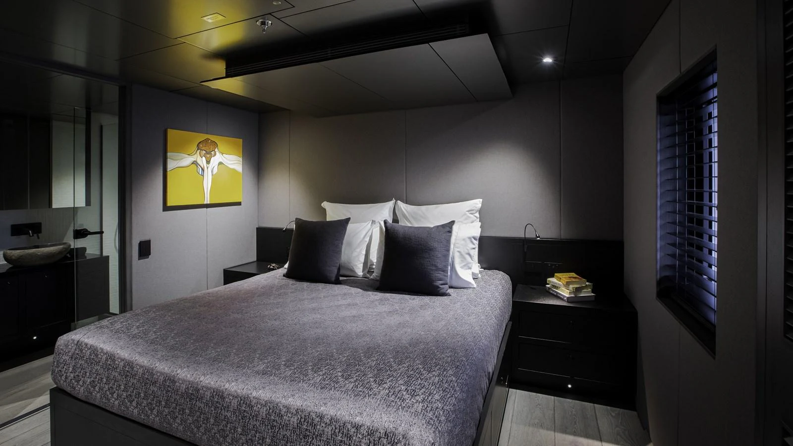 A luxurious stateroom with a large bed and modern decor. aboard THE BEAST Yacht for Sale