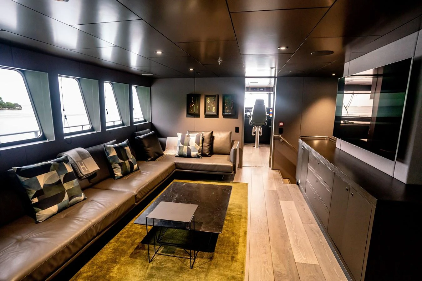 The yacht's salon features a modern and comfortable seating area with large windows providing ample natural light. aboard THE BEAST Yacht for Sale