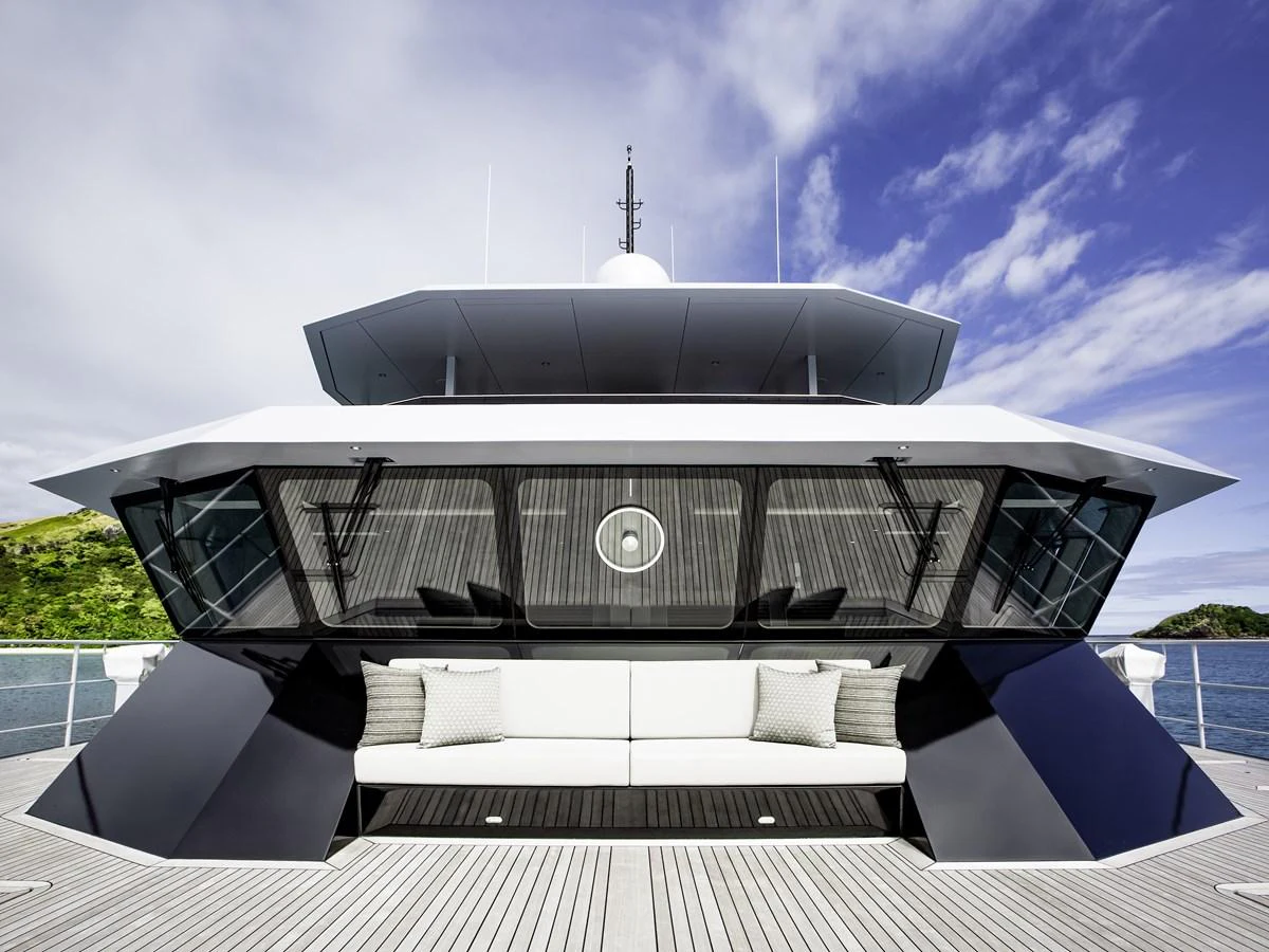 The yacht's sleek and modern exterior features a spacious deck with comfortable seating, set against a backdrop of clear skies and calm waters. aboard THE BEAST Yacht for Sale