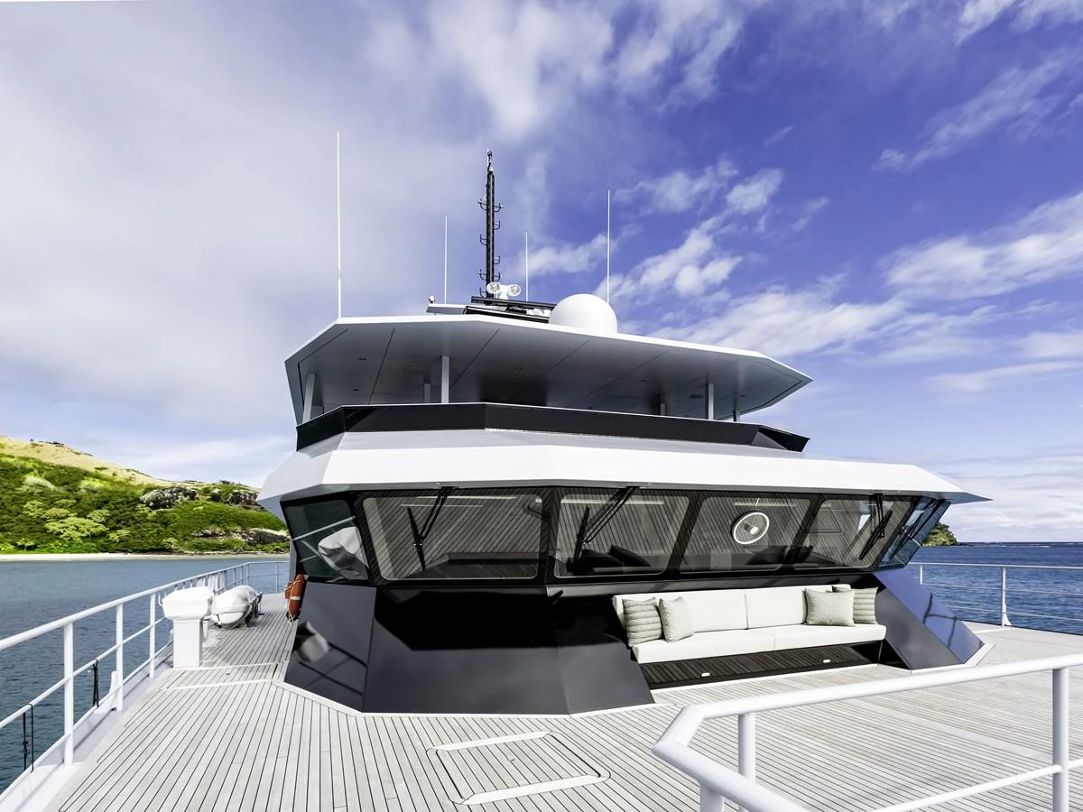 The yacht's foredeck offers a spacious and inviting area with a sleek, modern design against a stunning backdrop of blue skies and calm waters. aboard THE BEAST Yacht for Sale