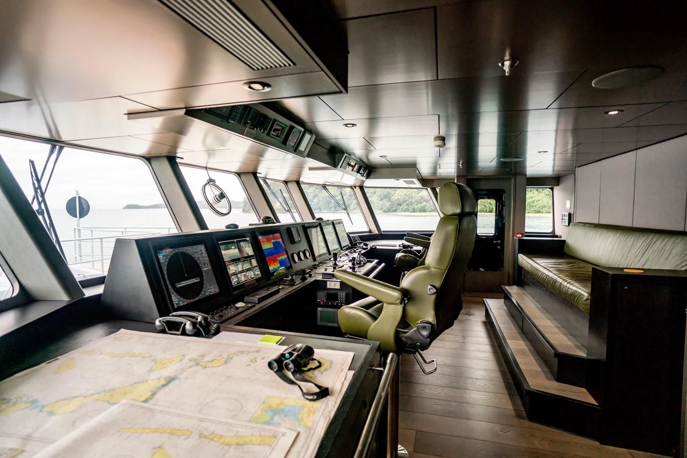 The helm station features advanced navigation equipment and a comfortable seating area with panoramic views. aboard THE BEAST Yacht for Sale