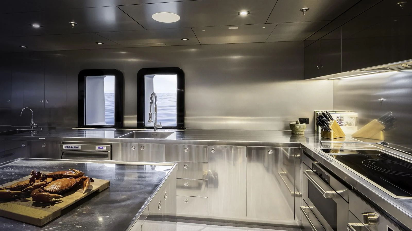 The yacht's galley features sleek stainless steel surfaces and modern appliances, creating a professional and efficient cooking environment. aboard THE BEAST Yacht for Sale