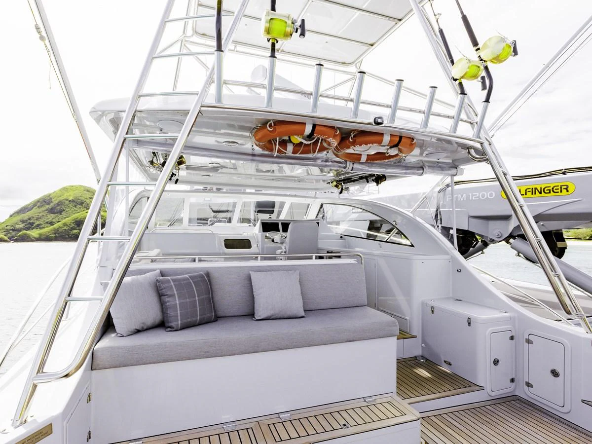 The yacht's aft deck features a comfortable seating area with plush cushions and a well-organized layout. aboard THE BEAST Yacht for Sale
