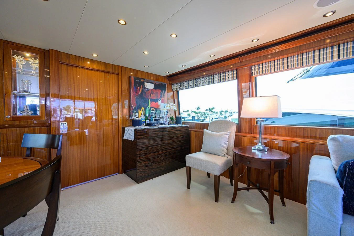 The salon features elegant wood paneling, comfortable seating, and large windows for natural light. aboard SAPPHIRE Yacht for Sale