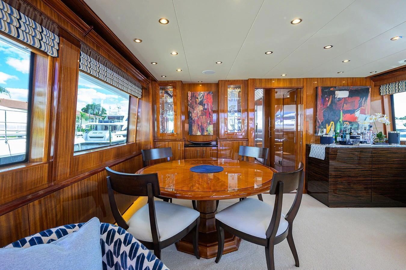 The yacht's dining area features elegant wood paneling and large windows for a luxurious dining experience. aboard SAPPHIRE Yacht for Sale