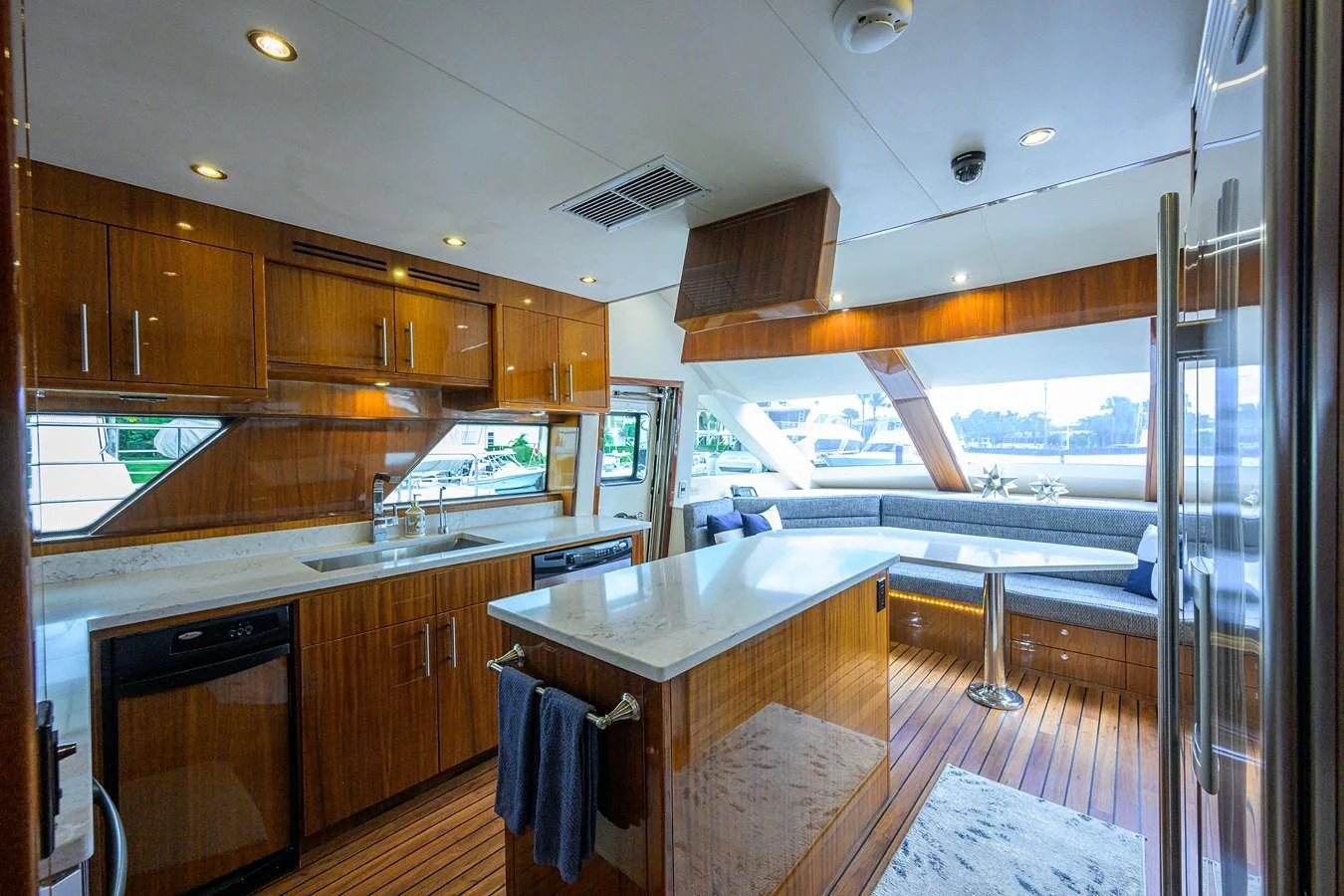 The yacht's galley features elegant wood cabinetry, a spacious countertop, and ample seating with panoramic windows. aboard SAPPHIRE Yacht for Sale