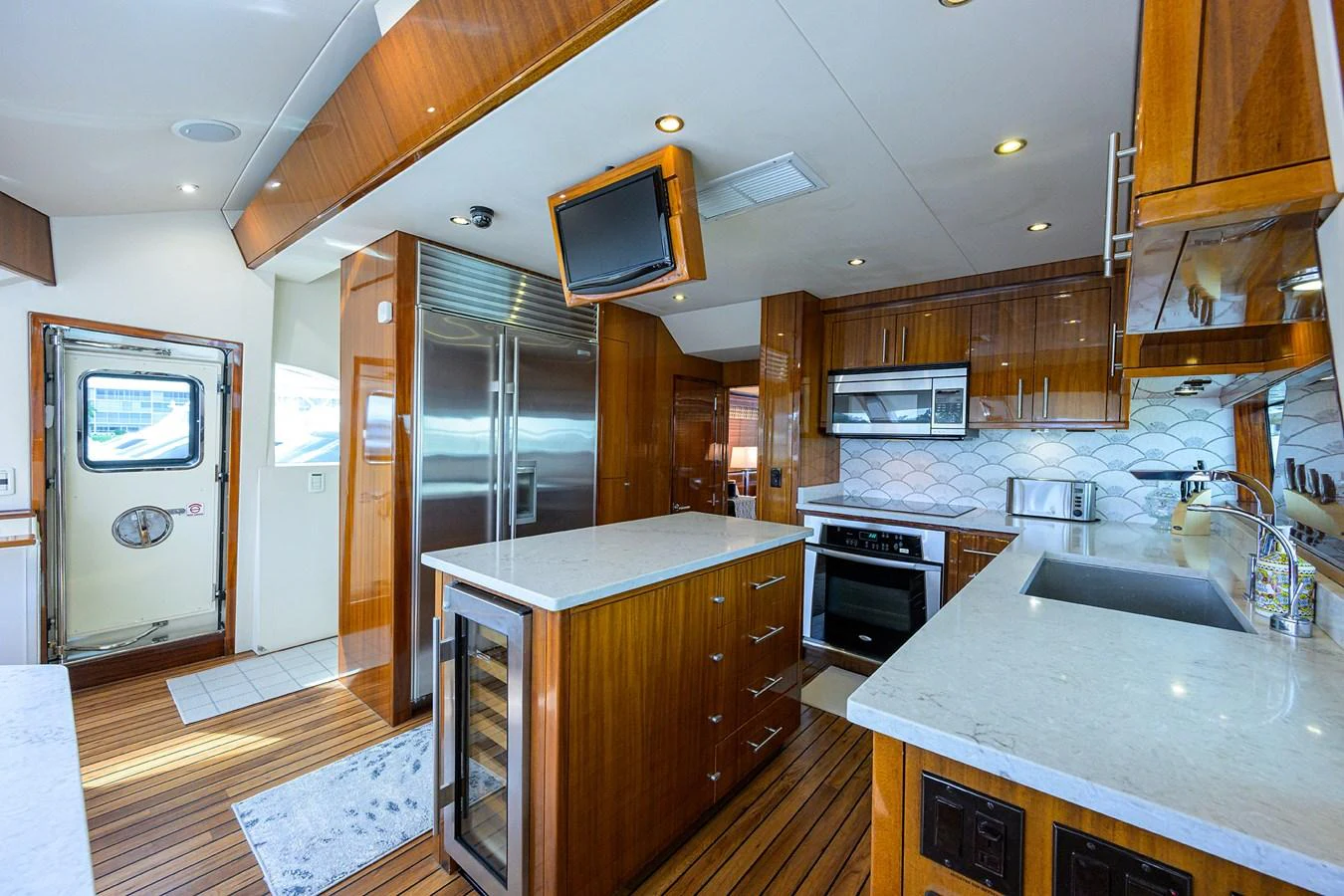 The galley features modern appliances and ample counter space with a warm wooden finish. aboard SAPPHIRE Yacht for Sale