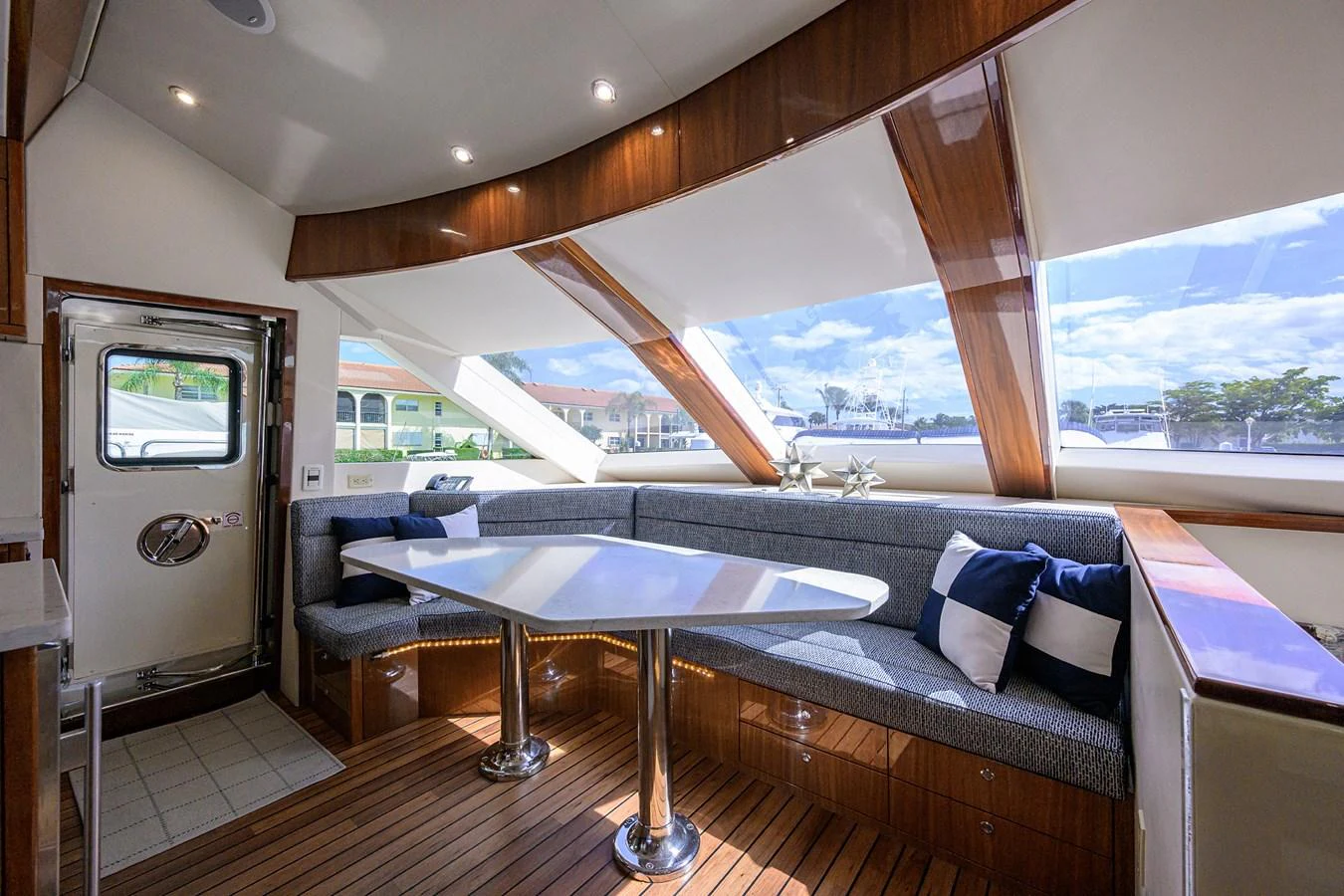 The salon features a sleek dining area with panoramic windows offering stunning views. aboard SAPPHIRE Yacht for Sale