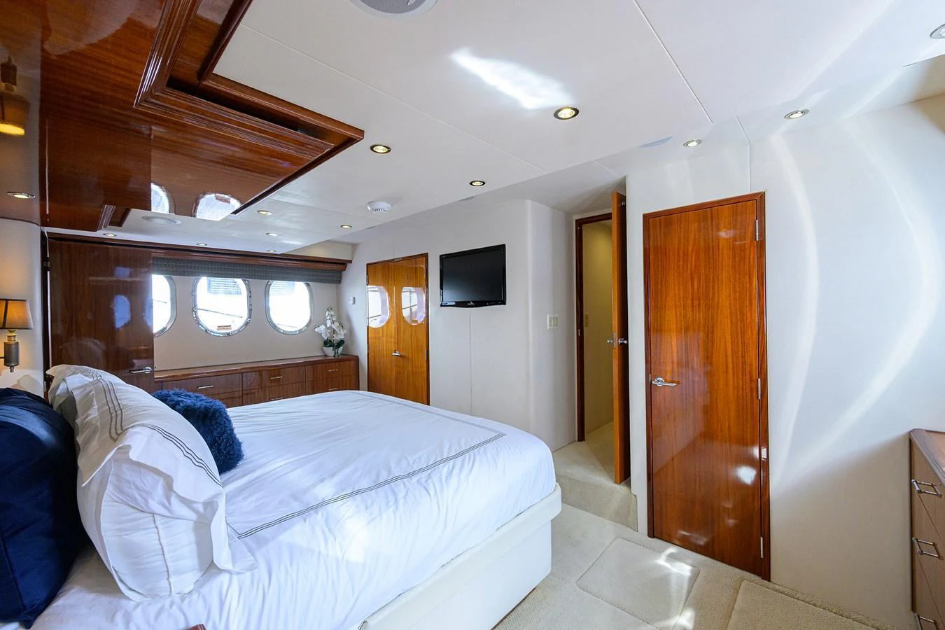 The master stateroom features luxurious bedding and elegant wood finishes, creating a serene and sophisticated retreat. aboard SAPPHIRE Yacht for Sale