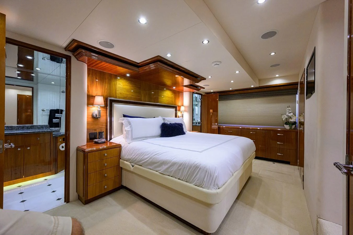 The master stateroom features a luxurious bed with elegant wooden accents and modern lighting. aboard SAPPHIRE Yacht for Sale