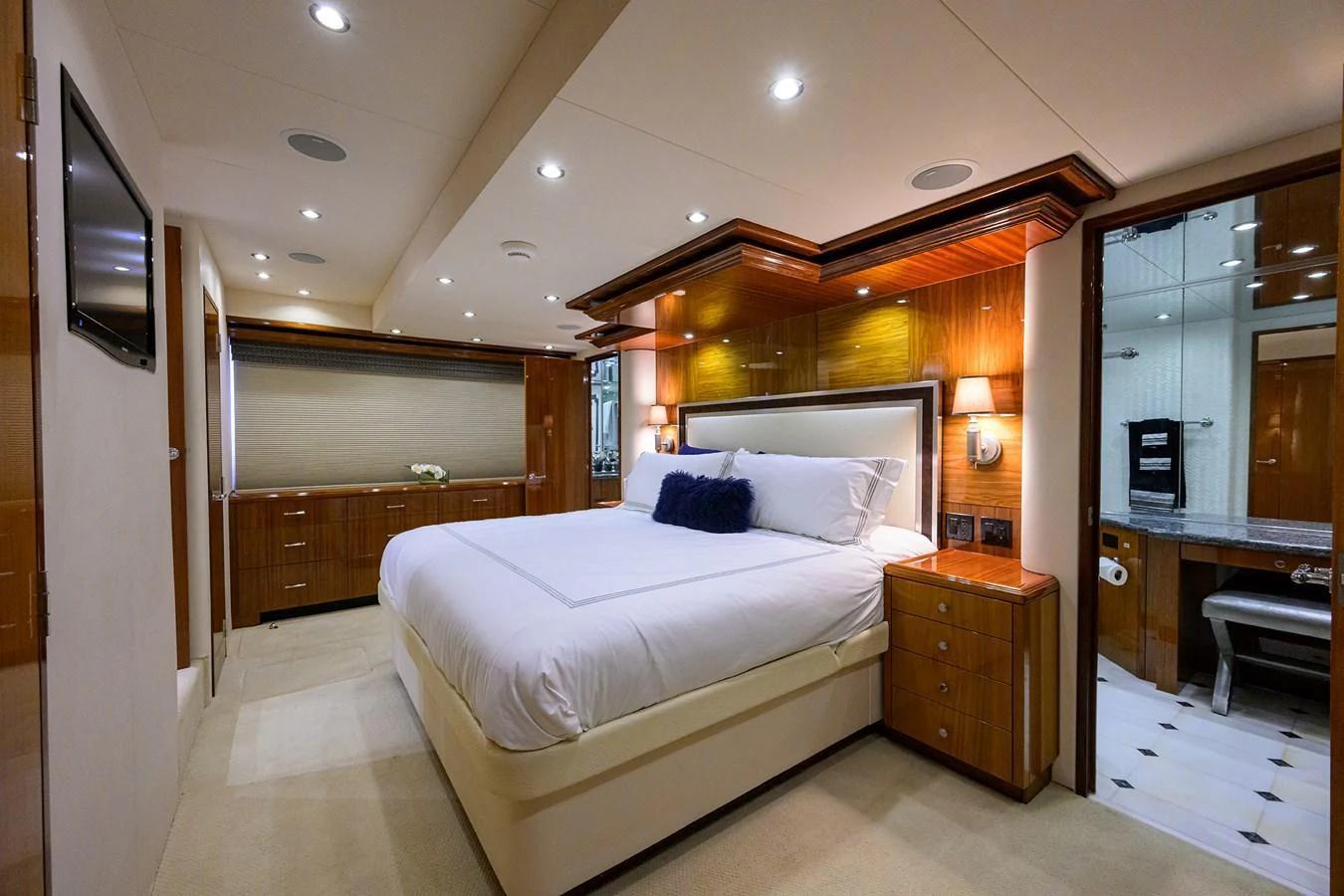 The master stateroom features a luxurious bed with elegant wood paneling and ample lighting. aboard SAPPHIRE Yacht for Sale