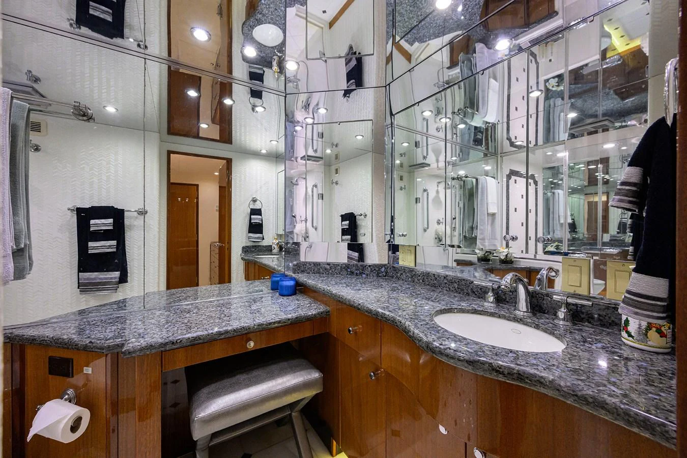 The yacht's bathroom features elegant granite countertops and mirrored walls, creating a spacious and luxurious feel. aboard SAPPHIRE Yacht for Sale