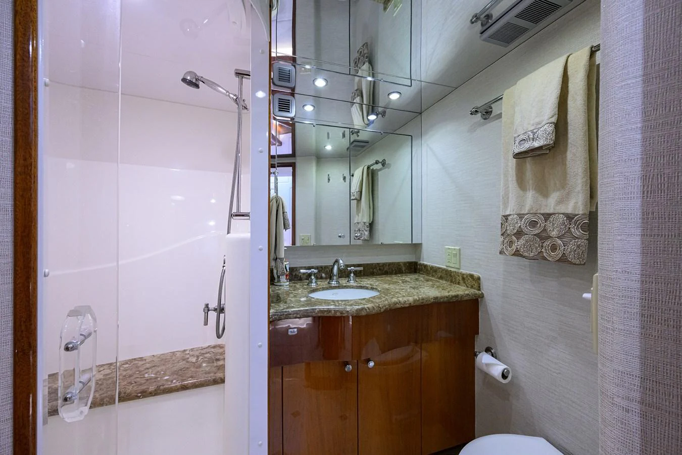 The yacht's bathroom features a sleek design with a granite countertop and modern fixtures. aboard SAPPHIRE Yacht for Sale
