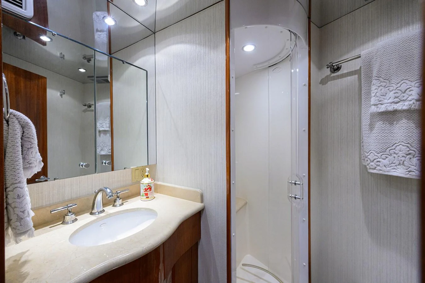 The yacht's bathroom features a sleek design with a glass-enclosed shower and elegant fixtures. aboard SAPPHIRE Yacht for Sale