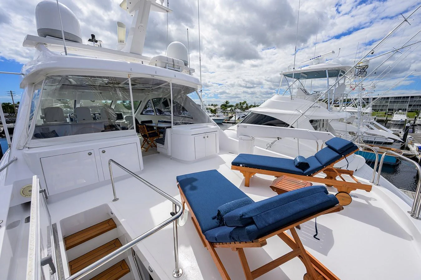 The flybridge offers a spacious and inviting area with comfortable lounge chairs and a stunning view of the marina. aboard SAPPHIRE Yacht for Sale