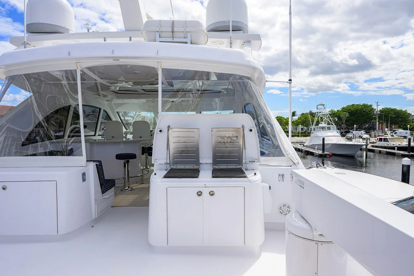 The yacht's aft deck features a clean and functional outdoor kitchen area with a view of the marina. aboard SAPPHIRE Yacht for Sale