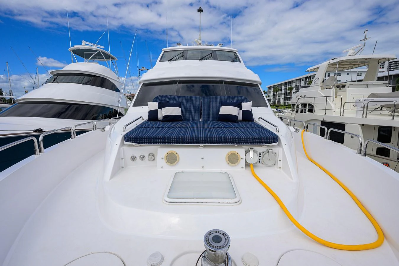 The foredeck features a comfortable seating area with striped cushions, perfect for relaxing under the open sky. aboard SAPPHIRE Yacht for Sale