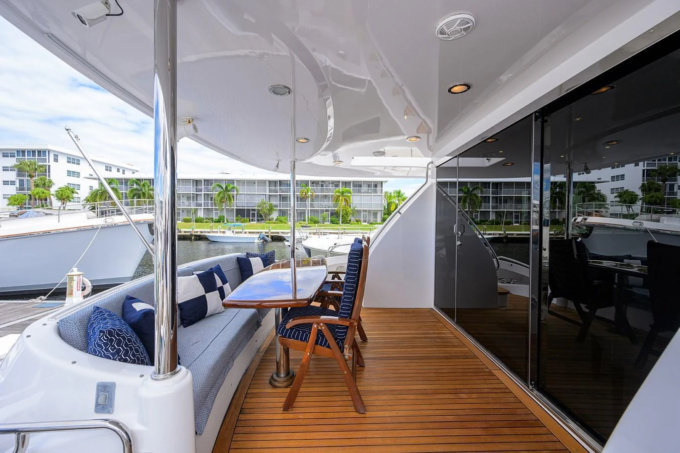 The aft deck features a comfortable seating area with a wooden table, perfect for alfresco dining. aboard SAPPHIRE Yacht for Sale