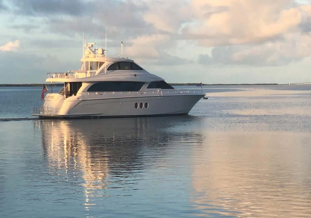 A sleek yacht glides gracefully on calm waters under a serene sky. aboard SAPPHIRE Yacht for Sale