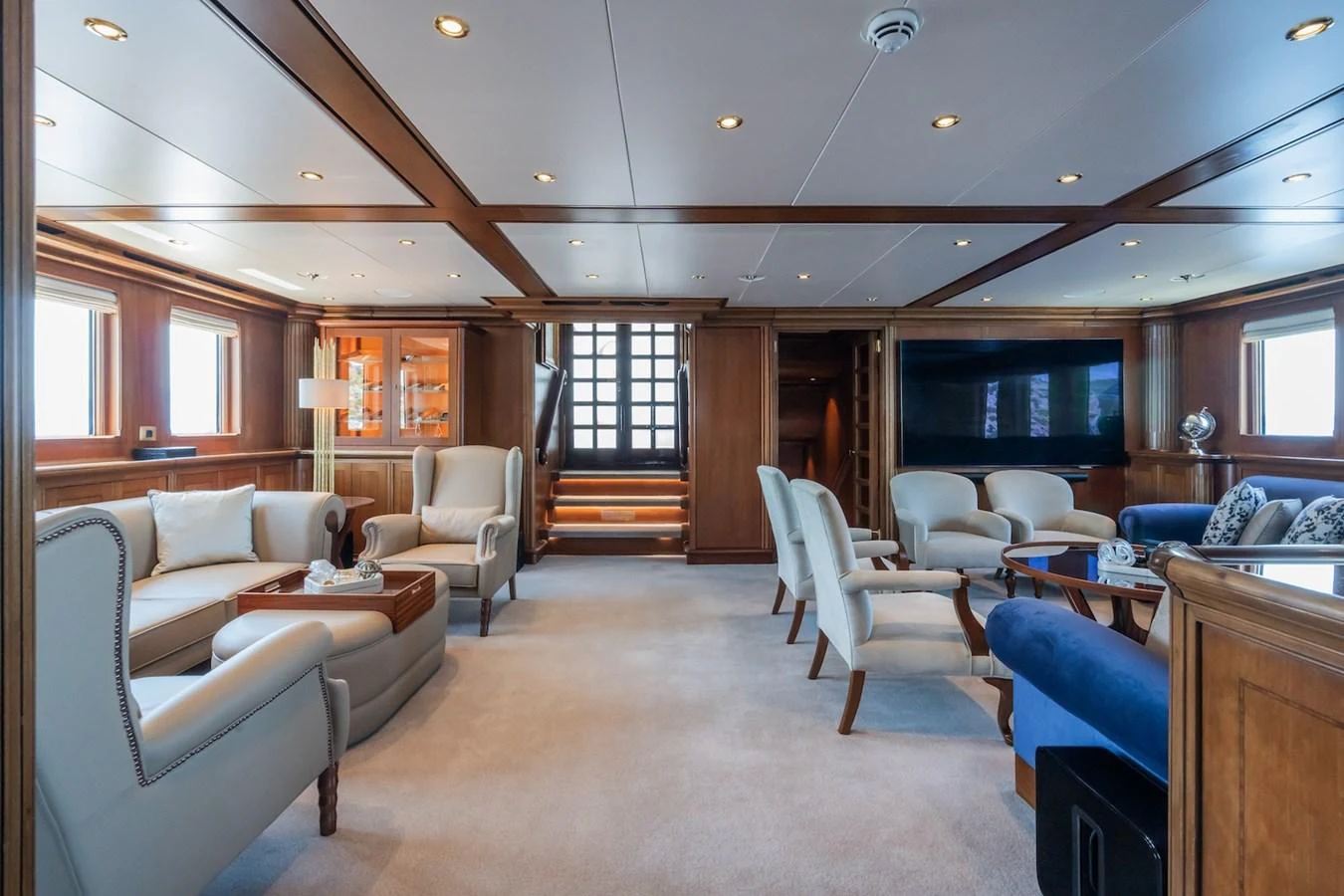 a living room with a staircase aboard THE LANGLEY Yacht for Sale