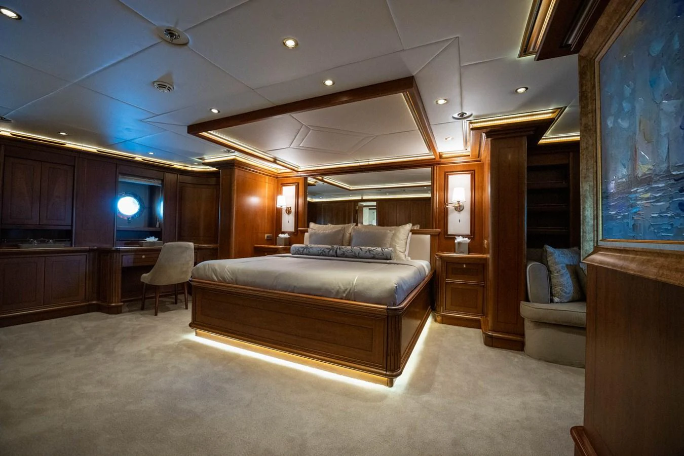 a bedroom with a bed and a desk aboard THE LANGLEY Yacht for Sale