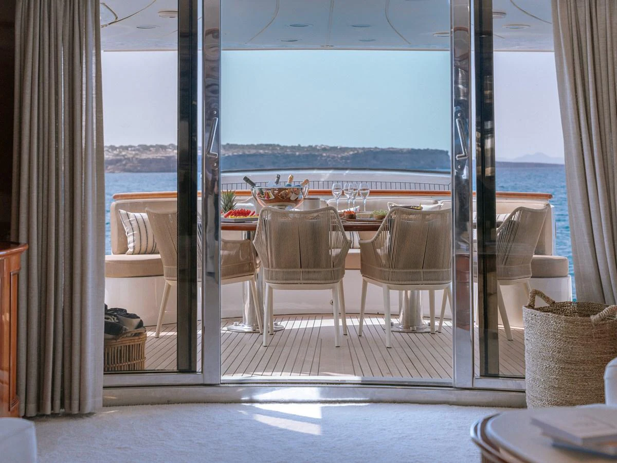 The aft deck offers a serene dining area with a stunning view of the sea. aboard FRIENDSHIP Yacht for Sale