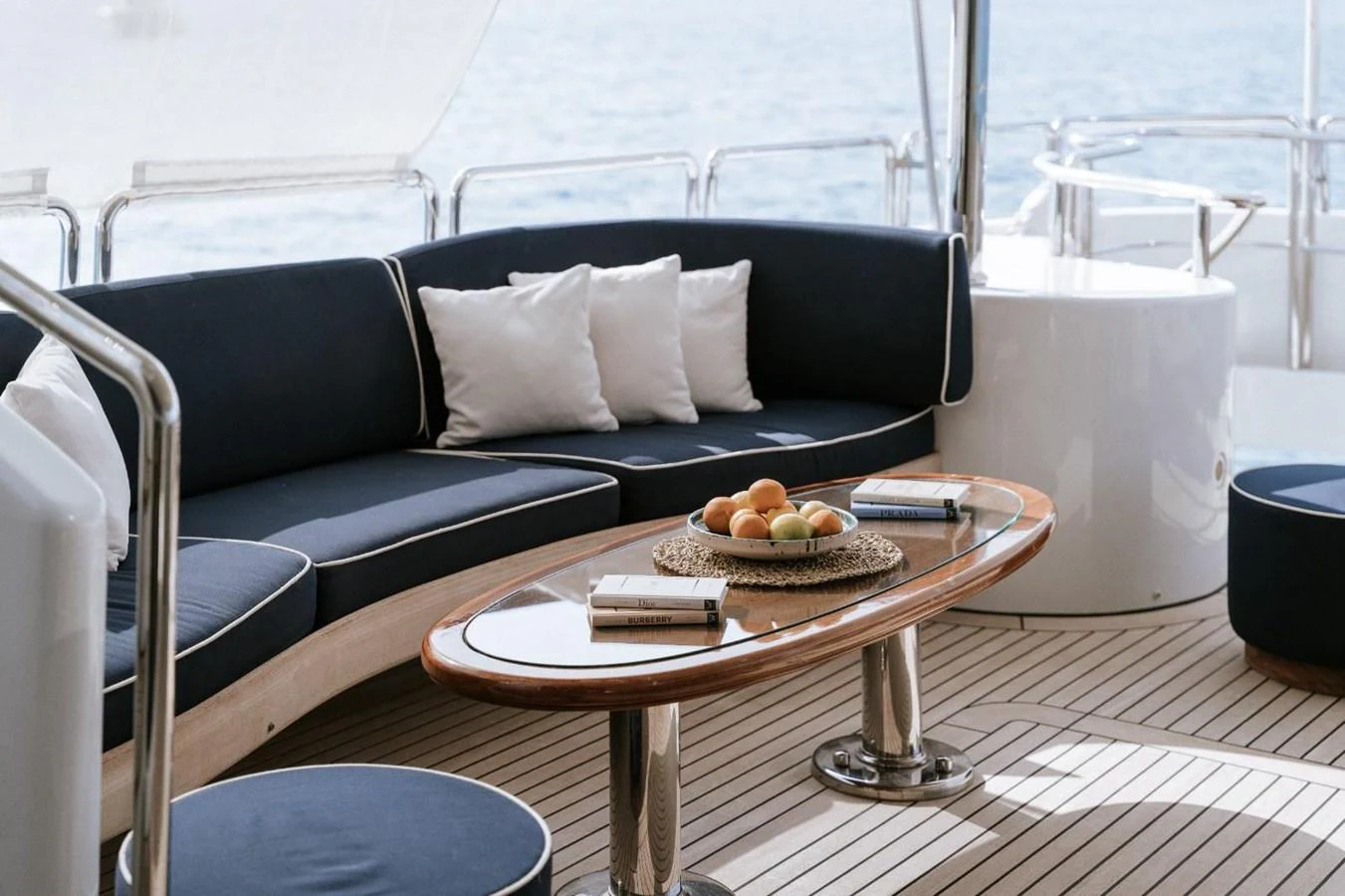 The aft deck features a stylish seating area with a wooden table and comfortable cushions, perfect for relaxation. aboard FRIENDSHIP Yacht for Sale